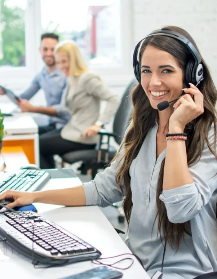 Young Lady wearing a headset taking calls in a call centre