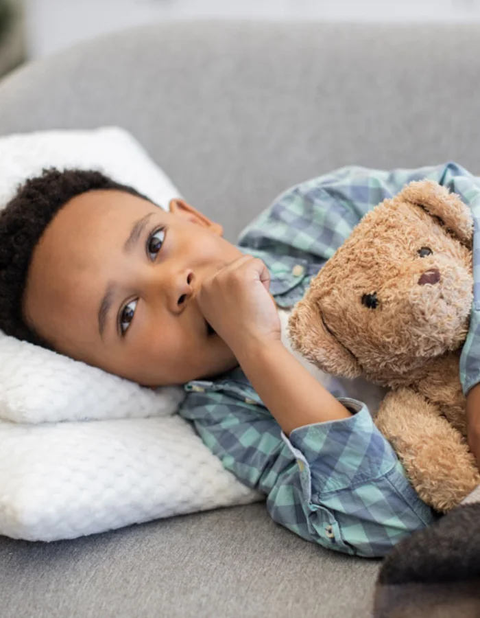 Young Child in bed with teddy bear